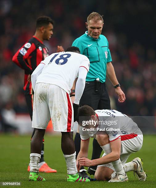 Philipp Wollscheid of Stoke City does up the shoelaces for Mame Biram Diouf during the Barclays Premier League match between A.F.C. Bournemouth and...