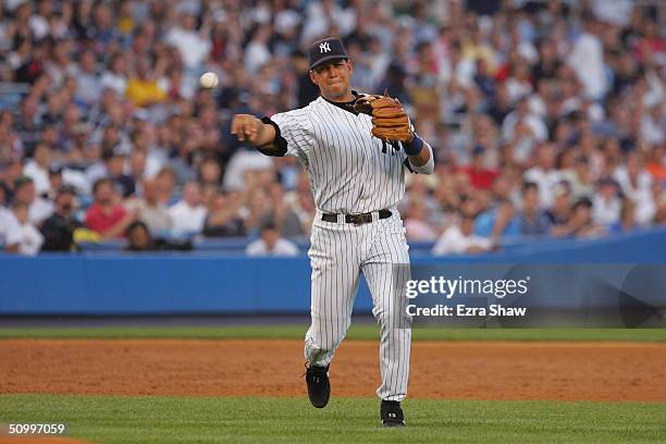 Infielder Alex Rodriguez of the New York Yankees throws the ball during the interleague game against the Colorado Rockies at Yankee Stadium on June...