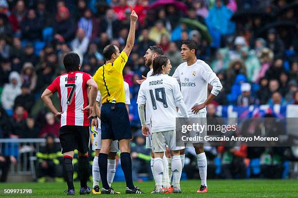 Referee Alfonso Javier Alvarez Izquierdo shows the red card to Raphael Varane during the La Liga match between Real Madrid CF and Athletic Club at...