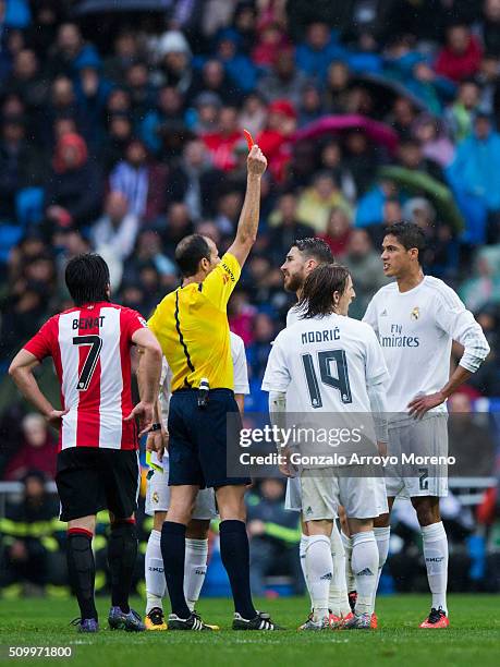 Referee Alfonso Javier Alvarez Izquierdo shows the red card to Raphael Varane during the La Liga match between Real Madrid CF and Athletic Club at...