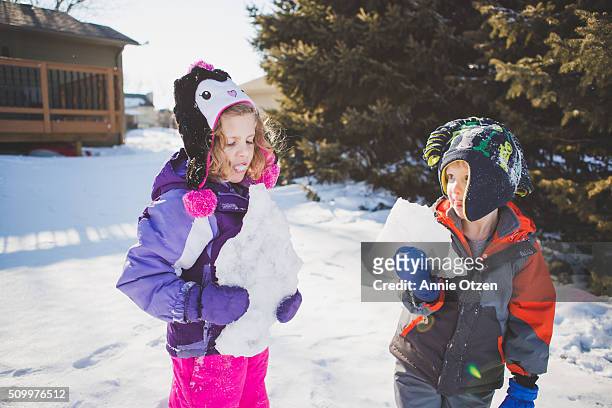 children holding chunks of ice. - frost bite stock-fotos und bilder