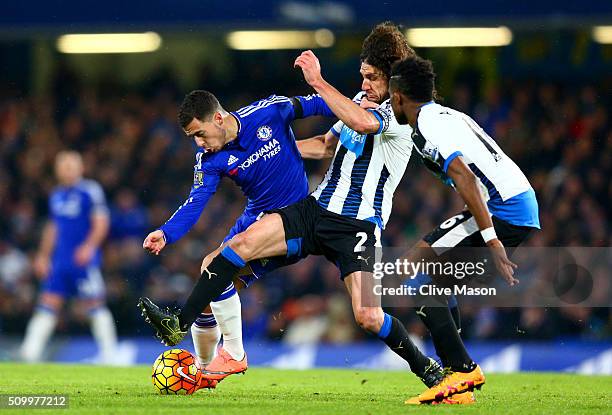 Eden Hazard of Chelsea and Fabricio Coloccini of Newcastle United compete for the ball during the Barclays Premier League match between Chelsea and...
