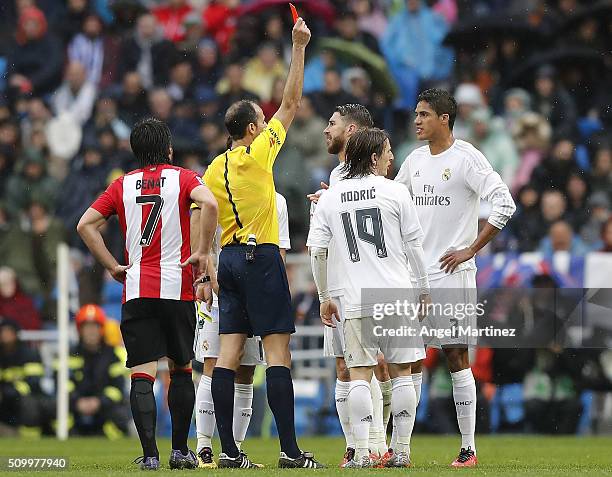 Referee Alfonso Alvarez shows a red card to Raphael Varane of Real Madrid during the La Liga match between Real Madrid CF and Athletic Club at...