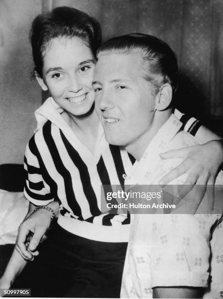 American rock musician Jerry Lee Lewis holds his second cousin and third wife Myra Brown in his lap at a press conference in the Westbury Hotel,...