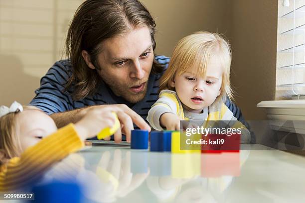 father playing with children - baby pointing stock pictures, royalty-free photos & images