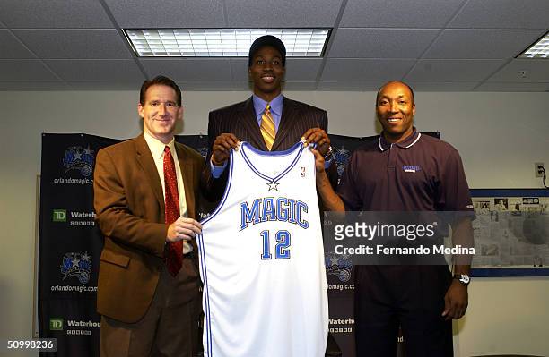 Orlando Magic General Manager John Weisbrod and Head Coach Johnny Davis introduce the first overall pick of the 2004 NBA Draft Dwight Howard to the...