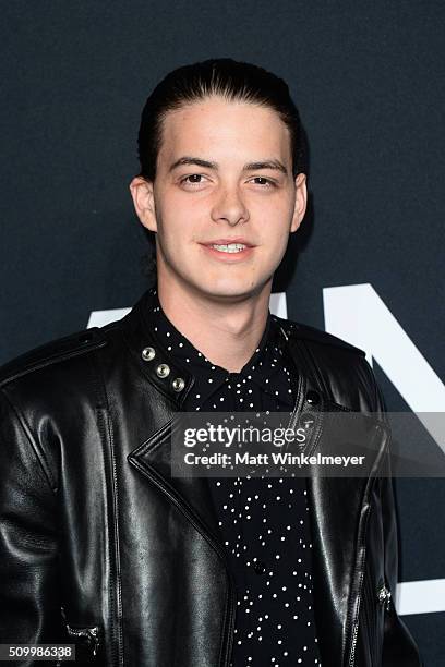 Actor Israel Broussard arrives at the Saint Laurent show at the Hollywood Palladium on February 10, 2016 in Los Angeles, California.