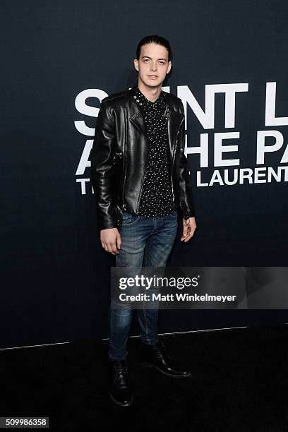 Actor Israel Broussard arrives at the Saint Laurent show at the Hollywood Palladium on February 10, 2016 in Los Angeles, California.