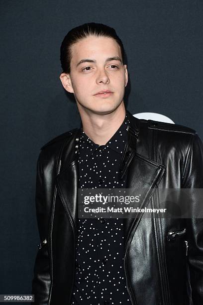 Actor Israel Broussard arrives at the Saint Laurent show at the Hollywood Palladium on February 10, 2016 in Los Angeles, California.