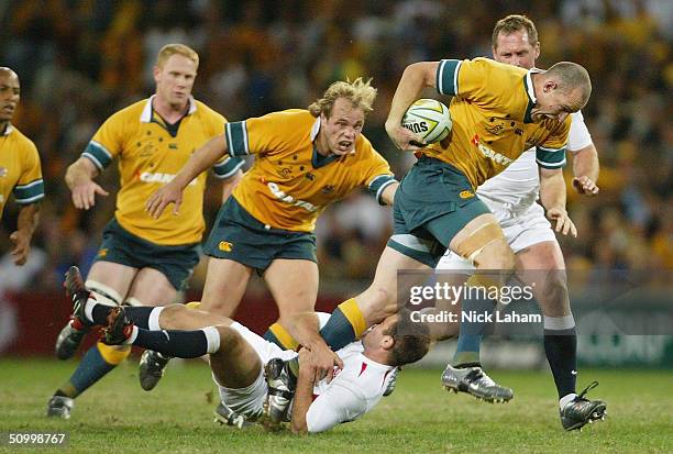 Stirling Mortlock of the Wallabies breaks the England defence during the rugby union international match between the Australian Wallabies and England...