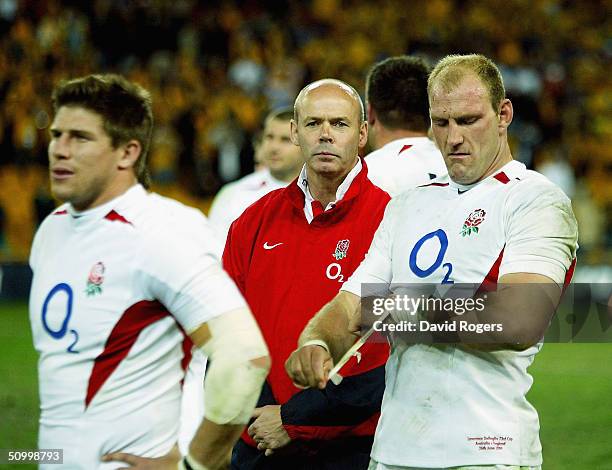 Lawrence Dallaglio, the England captain looks dejected together with Head Coach Sir Clive Woodward after England lose the rugby union international...