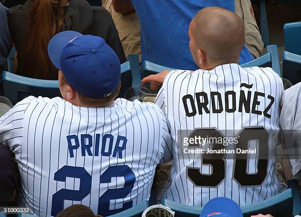 Fan wearing the jersey of Chicago Cub pitcher Mark Prior sits next to a fan wearing a jersey of Chicago White Sox outfielder Magglio Ordonez during a...