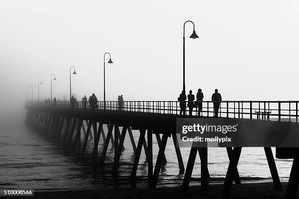 foggy afternoon at glenelg jetty - mollypix stock pictures, royalty-free photos & images