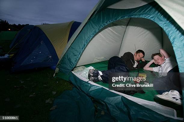 Fans watch the football As thay camp out overnight in the queue for middle Saturday at the Wimbledon Lawn Tennis Championship on June 26, 2004 at the...