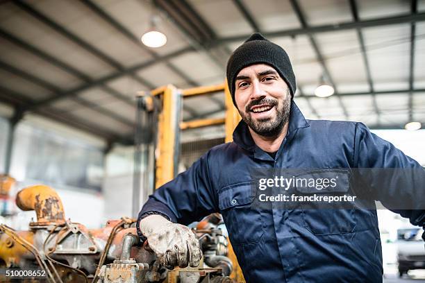 happiness mechanic on a garage - coveralls stock pictures, royalty-free photos & images