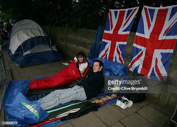 Fans camp out overnight in the queue for middle Saturday at the Wimbledon Lawn Tennis Championship on June 26, 2004 at the All England Lawn Tennis...