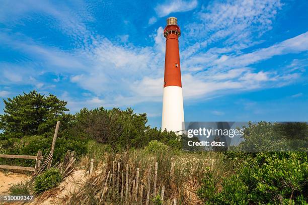 barnegat lighthouse, sand, beach, dune fence, new jersey - new jersey beach stock pictures, royalty-free photos & images