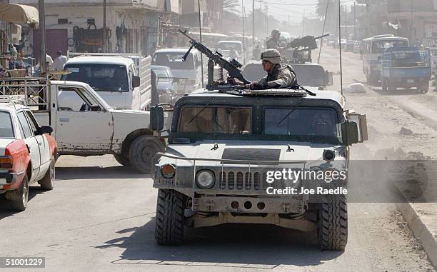 Army humvee from the 1st Infantry Division drives through the streets June 27, 2004 of Baqouba, Iraq. The city remained relatively quiet three days...