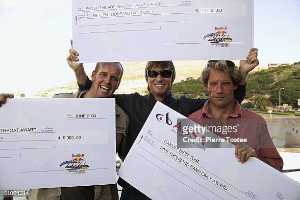 Award winners in the Red Bull Big Wave Africa Doug Young , Grant 'Twiggy' Baker and Mickey Duffus pose with their winners cheques. Young was...