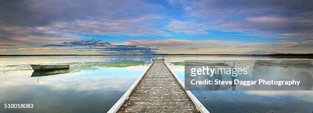 tranquil jetty reflections - tuggerah lake stock pictures, royalty-free photos & images