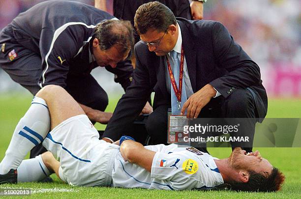 Czech defender Martin Jiranek is helped by his medical staff after an injury, 27 June 2004 at Dragao stadium in Porto, during the quarter final Euro...