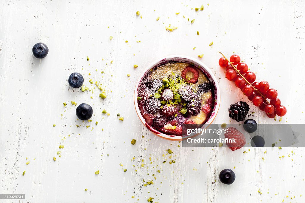 Berries soufflé on wooden board served as dessert