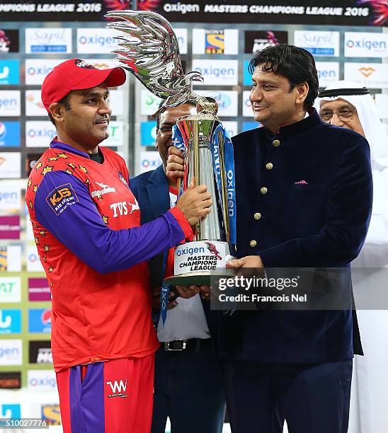 Virender Sehwag of Gemini Arabians receives the trophy following his team's victory at the end of the Final match of the Oxigen Masters Champions...