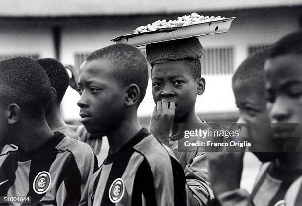 Young footballers involved with Inter Campus Project rest during a training session June 22, 2002 in Yaounde, Cameroon. Inter Campus is a social...