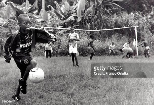 Young footballer involved with Inter Campus Project juggles the ball during a training session June 22, 2002 in Yaounde, Cameroon. Inter Campus is a...