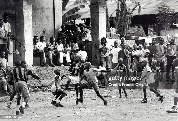 Young footballers involved with Inter Campus Project play a match June 26, 2002 in Douala, Cameroon. Inter Campus is a social program enacted by...