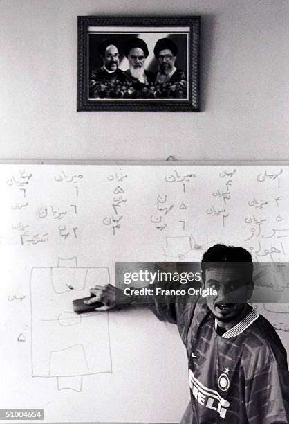 Coach involved with Inter Campus Project holds a lesson of soccer under the portrait of the Iranian Ayatollah April 21, 2002 in Teheran, Iran. Inter...