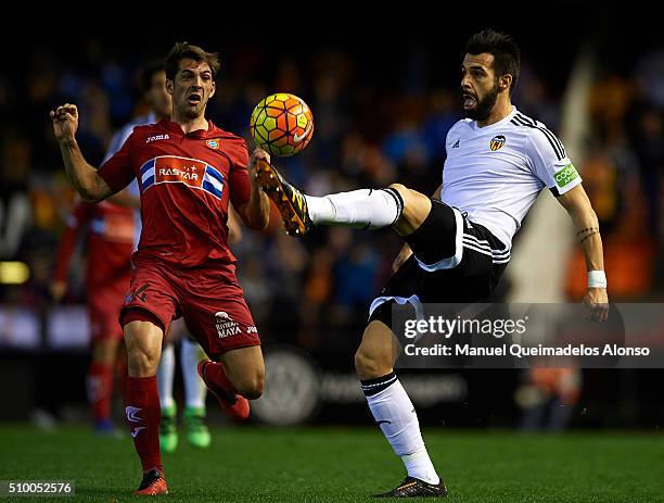 Alvaro Negredo of Valencia competes for the ball with Victor Sanchez of Espanyol during the La Liga match between Valencia CF and RCD Espanyol at...