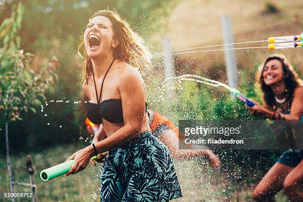 water gun fight - girls misbehaving stock pictures, royalty-free photos & images