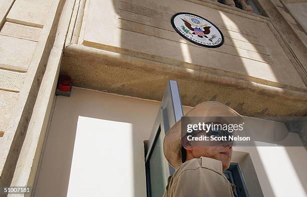 Private security guard stands at the entrance of the new but unfinished American Embassy building on June 29, 2004 in Baghdad, Iraq. Negroponte...