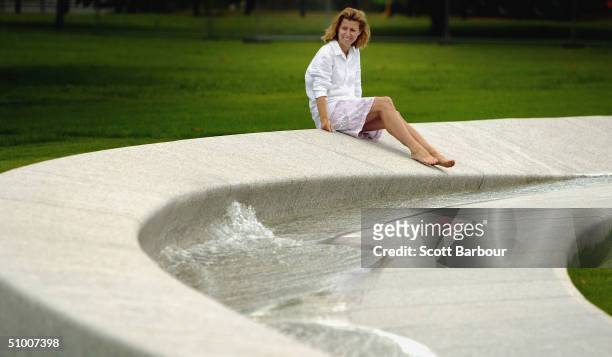 Lady sits beside The Diana, Princess of Wales Memorial Fountain in Hyde Park on June 29, 2004 in London, England. The fountain by the American...