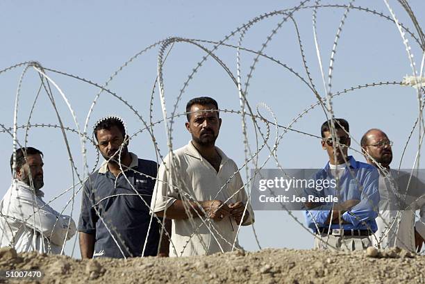 Family and friends wait for relatives to be released from the United States military operated Abu Ghraib prison on June 29, 2004 in Baghdad Iraq....