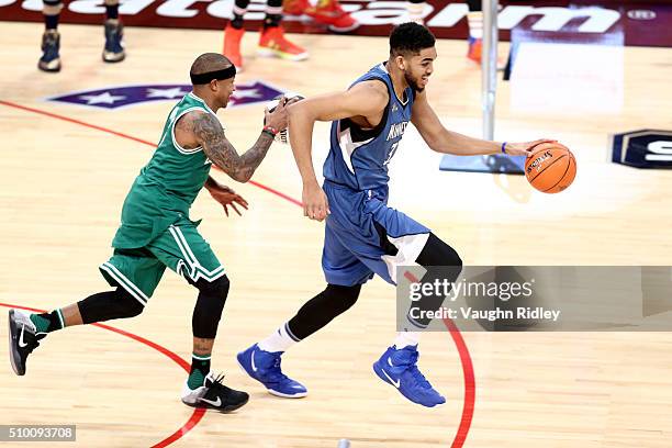 Isaiah Thomas of the Boston Celtics and Karl-Anthony Towns of the Minnesota Timberwolves dribble in the Taco Bell Skills Challenge during NBA...