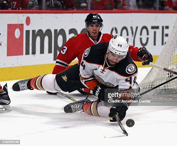 Nate Thompson of the Anaheim Ducks tries to control the puck after falling to ice in front of Viktor Svedberg of the Chicago Blackhawks at the United...