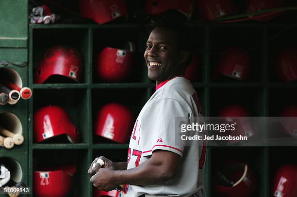 Vladimir Guerrero of Anaheim Angels smiles while he waits in the dugout before facing the Oakland Athletics during a MLB game at the Network...