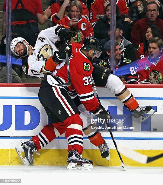 Michal Rozsival of the Chicago Blackhawks checks Ryan Kesler of the Anaheim Ducks into the boards at the United Center on February 13, 2016 in...