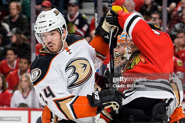 Simon Despres of the Anaheim Ducks hits Richard Panik of the Chicago Blackhawks next to goalie John Gibson in the second period of the NHL game at...