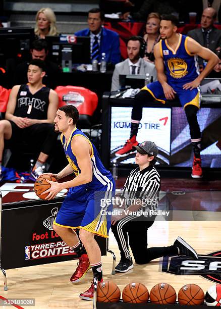 Klay Thompson of the Golden State Warriors shoots as teammate Stephen Curry looks on in the Foot Locker Three-Point Contest during NBA All-Star...