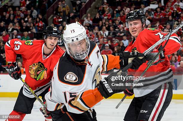 Ryan Getzlaf of the Anaheim Ducks watches for the puck in between Viktor Svedberg and Dennis Rasmussen of the Chicago Blackhawks in the second period...