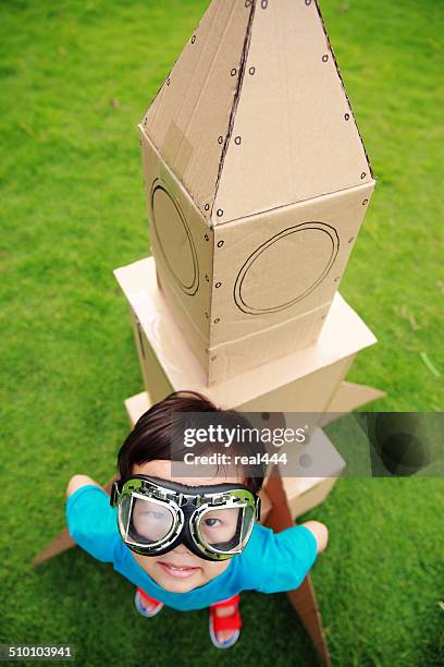 child and toy space rocket - toy rocket stock pictures, royalty-free photos & images