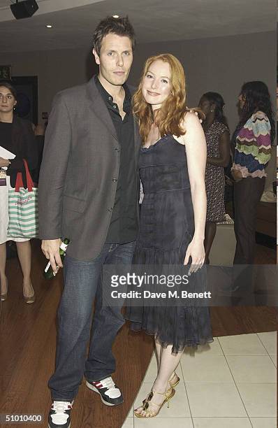 Actress Alicia Witt with her partner at the charity premiere of Michael Moore's controversial new film 'Fahrenheit 9/11' on June 29, 2004 at Vue West...