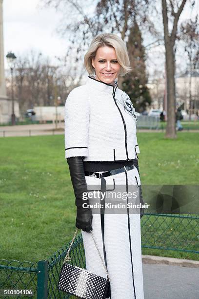 Faye Walichnowski wears a Chanel suit, gloves, and bag on day 3 of Paris Haute Couture Fashion Week Spring/Summer 2016, on January 26, 2015 in Paris,...