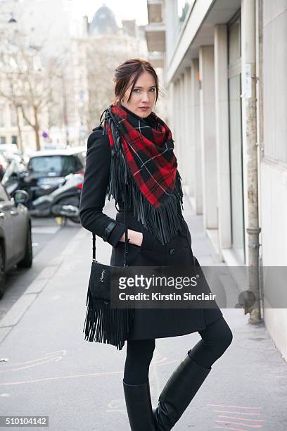 Artist and model Anastasia Shchipanova wears a Zadig and Voltaire scarf, Burberry coat, Yves Saint Laurent bag and Lanvin boots on day 3 of Paris...