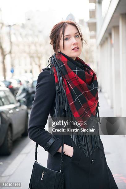 Artist and model Anastasia Shchipanova wears a Zadig and Voltaire scarf, Burberry coat, and Yves Saint Laurent bag on day 3 of Paris Haute Couture...