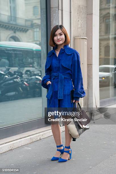 Fashion blogger Miu Pham wears a Xuan-Thu Nguyen coat, Laurence Dacade shoes and a Celine bag on day 3 of Paris Haute Couture Fashion Week...