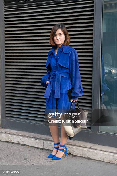 Fashion blogger Miu Pham wears a Xuan-Thu Nguyen coat, Laurence Dacade shoes and a Celine bag on day 3 of Paris Haute Couture Fashion Week...